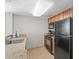 Efficient kitchen showcasing essential appliances, wooden cabinetry, and tiled floors for easy maintenance at 5200 N Ocean Blvd. # 957, Myrtle Beach, SC 29577