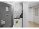 Laundry room with stacked washer and dryer and gray door at 5200 N Ocean Blvd. # 957, Myrtle Beach, SC 29577