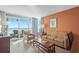 Inviting living room featuring comfortable seating, balcony access, and stunning ocean views at 5200 N Ocean Blvd. # 957, Myrtle Beach, SC 29577
