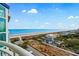 Scenic ocean view from a balcony showcasing the beach, coastline, and nearby residential area at 5200 N Ocean Blvd. # 957, Myrtle Beach, SC 29577