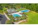 Aerial view of community pools, clubhouse, parking area, and lush green spaces at 570 Botany Loop Murrells Inlet # 570, Murrells Inlet, SC 29576