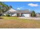 Charming single story home with brick accents, manicured landscaping, and attached two-car garage at 570 Botany Loop Murrells Inlet # 570, Murrells Inlet, SC 29576
