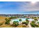 Stunning aerial view of a resort pool, waterway, and city skyline, ideal for vacationers at 5825 Catalina Dr. # 1133, North Myrtle Beach, SC 29582