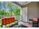 Inviting balcony with outdoor seating, offering a cozy space with lush green views and string lights at 5825 Catalina Dr. # 1133, North Myrtle Beach, SC 29582
