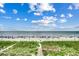 Beautiful beach scene with blue skies, ocean views, and sandy boardwalk entrance at 5825 Catalina Dr. # 1133, North Myrtle Beach, SC 29582