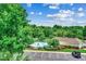 Scenic aerial view of a community pool and clubhouse with a parking lot and trees at 5825 Catalina Dr. # 1133, North Myrtle Beach, SC 29582