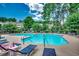 Inviting community pool area with sun loungers surrounded by lush landscaping and trees at 5825 Catalina Dr. # 1133, North Myrtle Beach, SC 29582