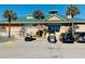 Activity center exterior with green roof, ample parking, and golf cart parking at 6001 - 1268 S Kings Hwy., Myrtle Beach, SC 29575