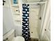 Clean and bright bathroom with a shower, built-in shelving, and whale-themed curtain at 6001 - 1268 S Kings Hwy., Myrtle Beach, SC 29575