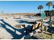 A cornhole area, complete with bean bag platforms, and benches on a sandy lot at 6001 - 1268 S Kings Hwy., Myrtle Beach, SC 29575