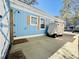 Private outdoor shower with wood accents, attached to a charming blue-colored building at 6001 - 1268 S Kings Hwy., Myrtle Beach, SC 29575