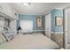 Inviting bedroom features bright blue walls, white furniture, and beach-themed decor at 6001 - 5010 S Kings Hwy., Myrtle Beach, SC 29575