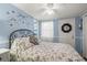 Cozy bedroom featuring light blue walls, a ceiling fan, and comfortable bedding at 6001 - 5010 S Kings Hwy., Myrtle Beach, SC 29575