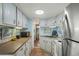 Quaint kitchen with updated countertops, stainless steel appliances, and painted cabinetry at 6001 - 5010 S Kings Hwy., Myrtle Beach, SC 29575