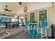 Charming covered porch featuring a cozy seating area, bright accents, and a welcoming atmosphere for outdoor relaxation at 6001 - 5010 S Kings Hwy., Myrtle Beach, SC 29575