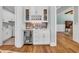 A well-appointed bar area featuring a beverage cooler, wine rack, and stylish backsplash at 6004 Flowerdale Ct., Myrtle Beach, SC 29579