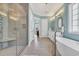 Bright bathroom with a glass-enclosed shower, soaking tub, and double vanity at 6004 Flowerdale Ct., Myrtle Beach, SC 29579