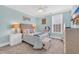 Comfortable bedroom with light blue walls, carpet and wicker furniture creating a serene retreat at 6004 Flowerdale Ct., Myrtle Beach, SC 29579