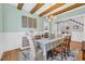 Well decorated dining room features hard wood floors, wood beams on the ceiling and a dining table at 6004 Flowerdale Ct., Myrtle Beach, SC 29579
