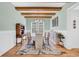 Cozy dining room featuring wood beams on the ceiling, wainscoting, hardwood floors and stylish decor at 6004 Flowerdale Ct., Myrtle Beach, SC 29579