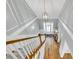 Elegant foyer featuring staircase with a modern chandelier, with beautiful hardwood floors and trim at 6004 Flowerdale Ct., Myrtle Beach, SC 29579