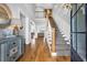 Bright foyer with hardwood floors, staircase with carpet runner, and an open view into the living room at 6004 Flowerdale Ct., Myrtle Beach, SC 29579