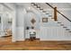 Efficient home office space under the staircase, featuring built-in desk and hardwood floors at 6004 Flowerdale Ct., Myrtle Beach, SC 29579