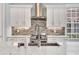 Close up detail of kitchen featuring white cabinets, stainless steel appliances, and tile backsplash at 6004 Flowerdale Ct., Myrtle Beach, SC 29579