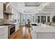 Spacious kitchen with stainless steel appliances, a large island with granite counters, and modern pendant lighting at 6004 Flowerdale Ct., Myrtle Beach, SC 29579