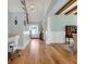 Open living area with hardwood floors, staircase, home desk space, and a view into the dining room at 6004 Flowerdale Ct., Myrtle Beach, SC 29579