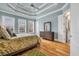 Spacious main bedroom with tray ceiling, hardwood floors, and bright, natural light at 6004 Flowerdale Ct., Myrtle Beach, SC 29579