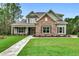Beautiful home with stone accents, manicured lawn, and a charming walkway enhances curb appeal at 6013 Blease Ct., Myrtle Beach, SC 29588