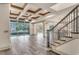 Spacious living room featuring hardwood-style tile floors, coffered ceilings, and a staircase at 6013 Blease Ct., Myrtle Beach, SC 29588