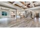 Open-concept living space with hardwood-style tile, coffered ceilings, and a modern kitchen at 6013 Blease Ct., Myrtle Beach, SC 29588