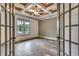 Office space with coffered ceilings, hardwood-style floors, and natural light streaming through the windows at 6013 Blease Ct., Myrtle Beach, SC 29588
