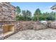 Outdoor kitchen and fireplace constructed with stone, stainless steel appliances, and brick pavers at 6013 Blease Ct., Myrtle Beach, SC 29588