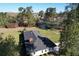 An aerial view of a cozy home with a large yard, mature trees and a pond in the background at 61 Lakewood Dr., Andrews, SC 29510
