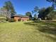 Spacious backyard surrounded by mature trees and lush green lawn at 61 Lakewood Dr., Andrews, SC 29510