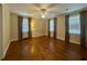 Bright bedroom with hardwood floors, ceiling fan, and lots of natural light at 61 Lakewood Dr., Andrews, SC 29510