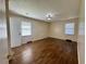 This bedroom has hardwood floors, two windows, and neutral tones at 61 Lakewood Dr., Andrews, SC 29510