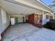 Covered carport featuring brick accents, neutral painted walls, and direct access to the home at 61 Lakewood Dr., Andrews, SC 29510