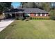 Charming brick home with manicured front yard, mature shrubs, and covered parking at 61 Lakewood Dr., Andrews, SC 29510