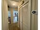 Hallway with coat closet and views to kitchen and living spaces at 61 Lakewood Dr., Andrews, SC 29510
