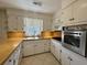 A kitchen featuring white cabinets, stainless appliances, and light countertops at 61 Lakewood Dr., Andrews, SC 29510