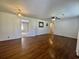 Bright living room with hardwood floors and neutral walls, featuring a ceiling fan and doorway access at 61 Lakewood Dr., Andrews, SC 29510