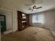 Cozy living room features a brick fireplace, ceiling fan, and neutral carpet and paint at 61 Lakewood Dr., Andrews, SC 29510