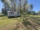Metal storage shed in a grassy backyard, perfect for outdoor equipment and lawncare items at 61 Lakewood Dr., Andrews, SC 29510