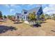 Large backyard with a patio, outdoor seating, and meticulous landscaping at 6121 Bolsena Place, Myrtle Beach, SC 29572