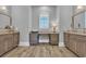 This bathroom features dual vanities with granite countertops and a makeup vanity below a window at 6121 Bolsena Place, Myrtle Beach, SC 29572
