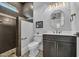 This bathroom features a tiled shower with glass partition, a vanity with drawers, and a modern light fixture at 6121 Bolsena Place, Myrtle Beach, SC 29572